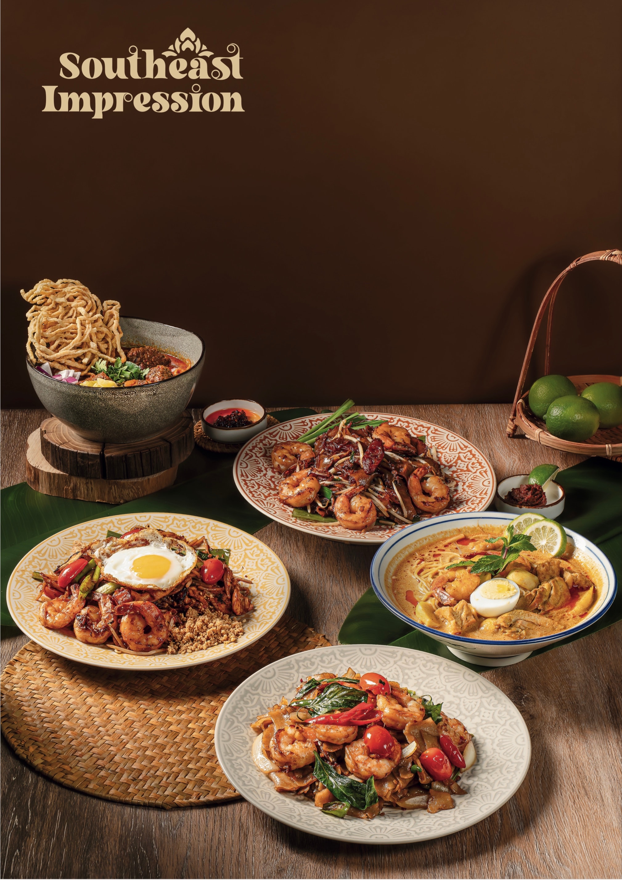 Char kway teow, curry laksa and mee goreng plated on a wooden table